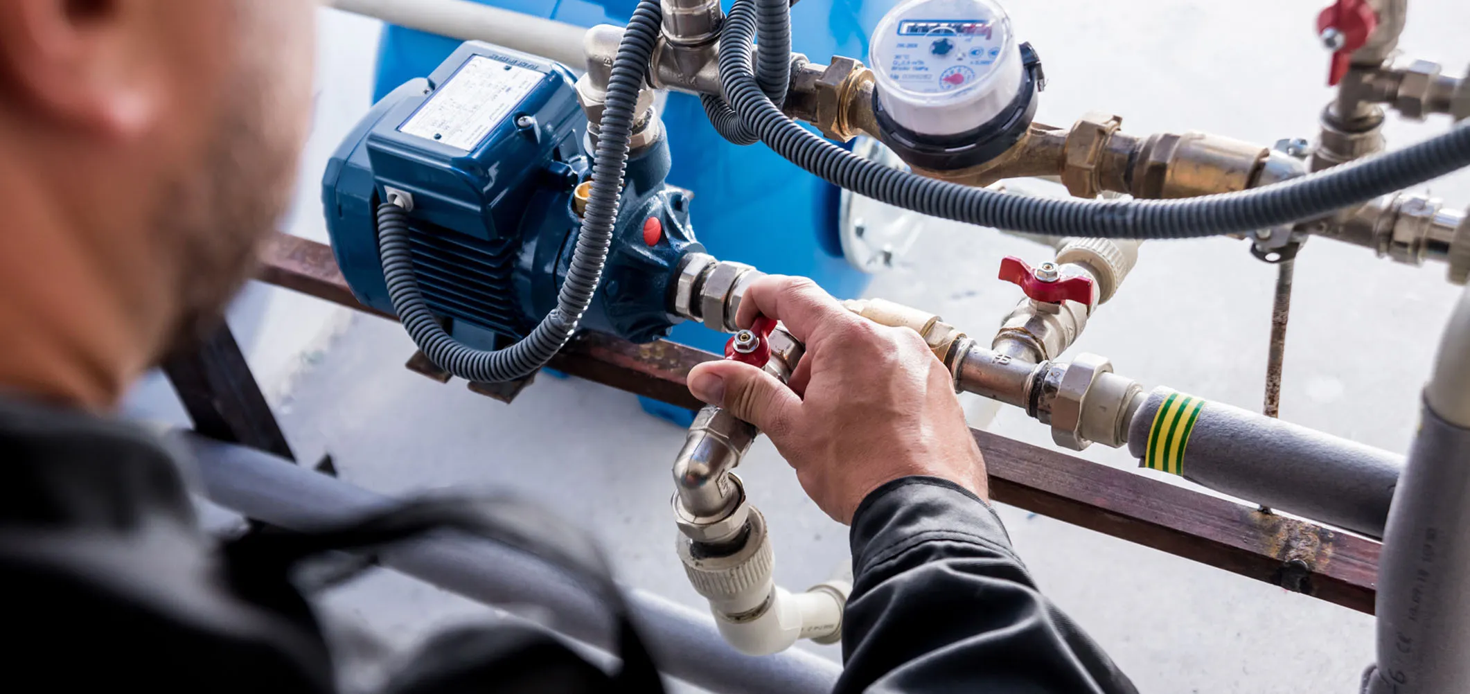Commercial plumbing system with pipes, valves, and a control panel installed in a utility room.
